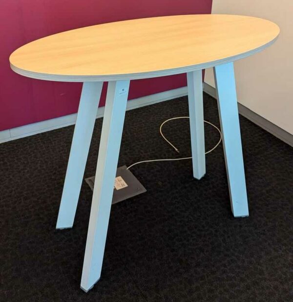 Table haute de marque STEELCASE plateau ovale en bois couleur hêtre, piètement oblique en acier laqué blanc. 100 x 120 x 60 cm. Localisation : 2 est