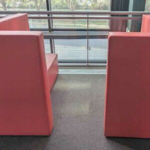 Espace de confidentialité de marque ABV comprenant 2 banquettes en face à face en simili cuir rose. 128 x 160 x 90 cm chaque. Localisation : 1er coursive