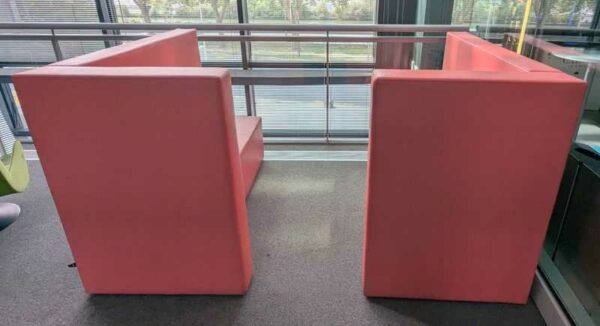 Espace de confidentialité de marque ABV comprenant 2 banquettes en face à face en simili cuir rose. 128 x 160 x 90 cm chaque. Localisation : 1er coursive