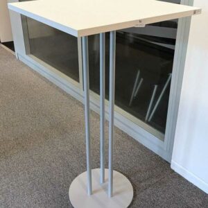 2 tables hautes à plateau carré en bois stratifié blanc reposant sur 3 pieds en métal sur base circulaire. 110 x 60 x 60 cm. Localisation : 3 est