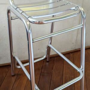 Paire de chaises hautes de marque RODET en aluminium. 98 x 41 x 55 cm. Localisation : Canada hall
