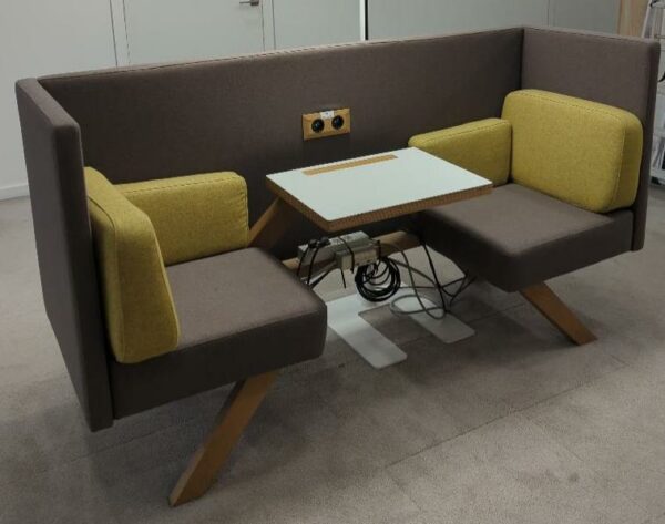 Espace de travail acoustique 2 personnes de marque Too the Zoo composé de 2 fauteuils en tissu marron, coussins vert jaune, 1 tablette et 2 prises électriques. 110 x 200 x 67 cm. Localisation : 9 avenue Percier 75008 Paris
