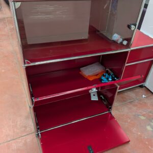 Meuble de marque USM HALLER de couleur rouge à 3 compartiments dont 1 ouvrant par 1 porte vitrée (fermée à clé) et 2 par portes à abattant. 109 x 77 x 38 cm. Localisation : 8 rue de la Fossé aux Leux 91700 Ste Geneviève des Bois – Image 2