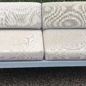 Canapé extérieur 2 places design Pagnon et Pelhaître modèle Bellevie édition Fermob, structure en aluminium gris, assise et dossier recouvert de tissu outdoor acrylique gris. 71 x 160 x 75 cm. (usures). Localisation : 30 rue Beauregard 60440 Nanteuil-le-Haudouin