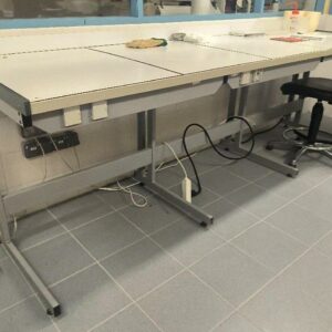Paillasse de laboratoire adossée de marque Cometal, plateau en carrelage blanc, piètement en métal gris, avec prises électriques intégrées. Dim : 99 x 273 x 80 cm. (labo)