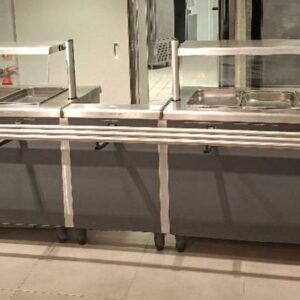 2 buffets chauffants à bain marie à 4 compartiments pour bac gastro chacun, avec placard ouvrant à portes coulissantes et rail à plateaux. 130 x 380 x 80 cm. Largeur du rail : 30 cm.